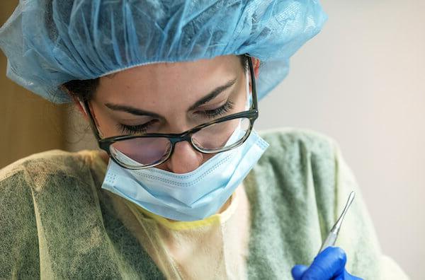 Dentist working on a person's teeth.